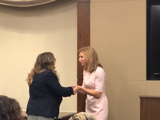 Audrey Busch shaking hands with Kelsey Mishkin
